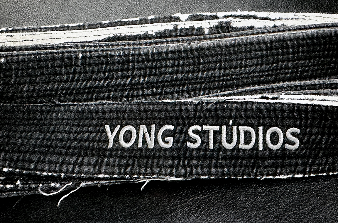 Image of a worn out and shredded black belt.